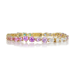 Introducing the Mixed Shape Diamond and Multicolor Sapphire Tennis Bracelet, an exquisite 18K yellow gold piece showcasing an array of vibrant sapphires and sparkling mixed-shape diamonds set in intricate patterns along the band.
