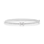 The East-West Emerald Cut Diamond Pavé Bangle is crafted in 18K white gold, embellished with pavé-set diamonds and highlighted by a rectangular emerald cut diamond at its center.