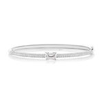 Introducing the East-West Set Emerald Cut Diamond Pavé Bangle: a silver bangle bracelet adorned with two rows of pavé diamonds and highlighted by a striking rectangular emerald-cut diamond at its center.