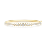 The Graduated Hexagon Bezel Set Diamond Pavé Bangle, crafted in 18k gold, showcases a central row of round, graduated SI clarity diamonds bezel set in hexagonal frames, accented by two lines of pavé diamonds along each edge and displayed on a white background.