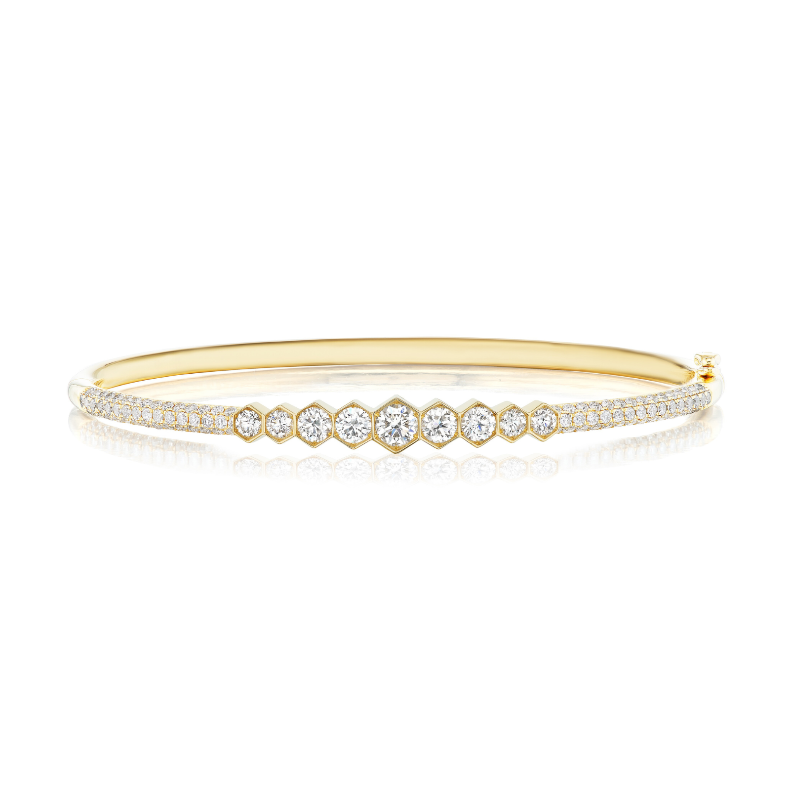 The Graduated Hexagon Bezel Set Diamond Pavé Bangle, crafted in 18k gold, showcases a central row of round, graduated SI clarity diamonds bezel set in hexagonal frames, accented by two lines of pavé diamonds along each edge and displayed on a white background.