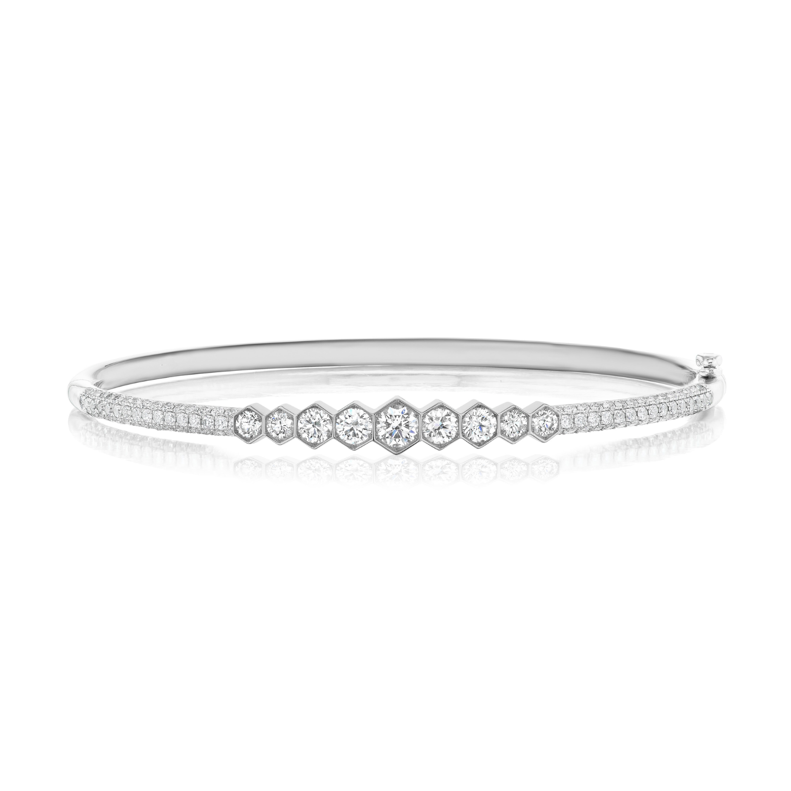 The Graduated Hexagon Bezel Set Diamond Pavé Bangle, a sleek silver bracelet showcased against a white background, features a row of SI clarity round-cut diamonds set in graduated hexagon bezels at the center and pavé-set diamonds adorning the band.