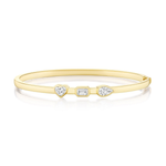 Introducing the Trio Bezel Set Mixed Shape Diamond Bangle in Yellow Gold—an elegant 18k gold bracelet showcasing a heart-shaped, an emerald-cut, and a pear-shaped diamond bezel-set at its center.