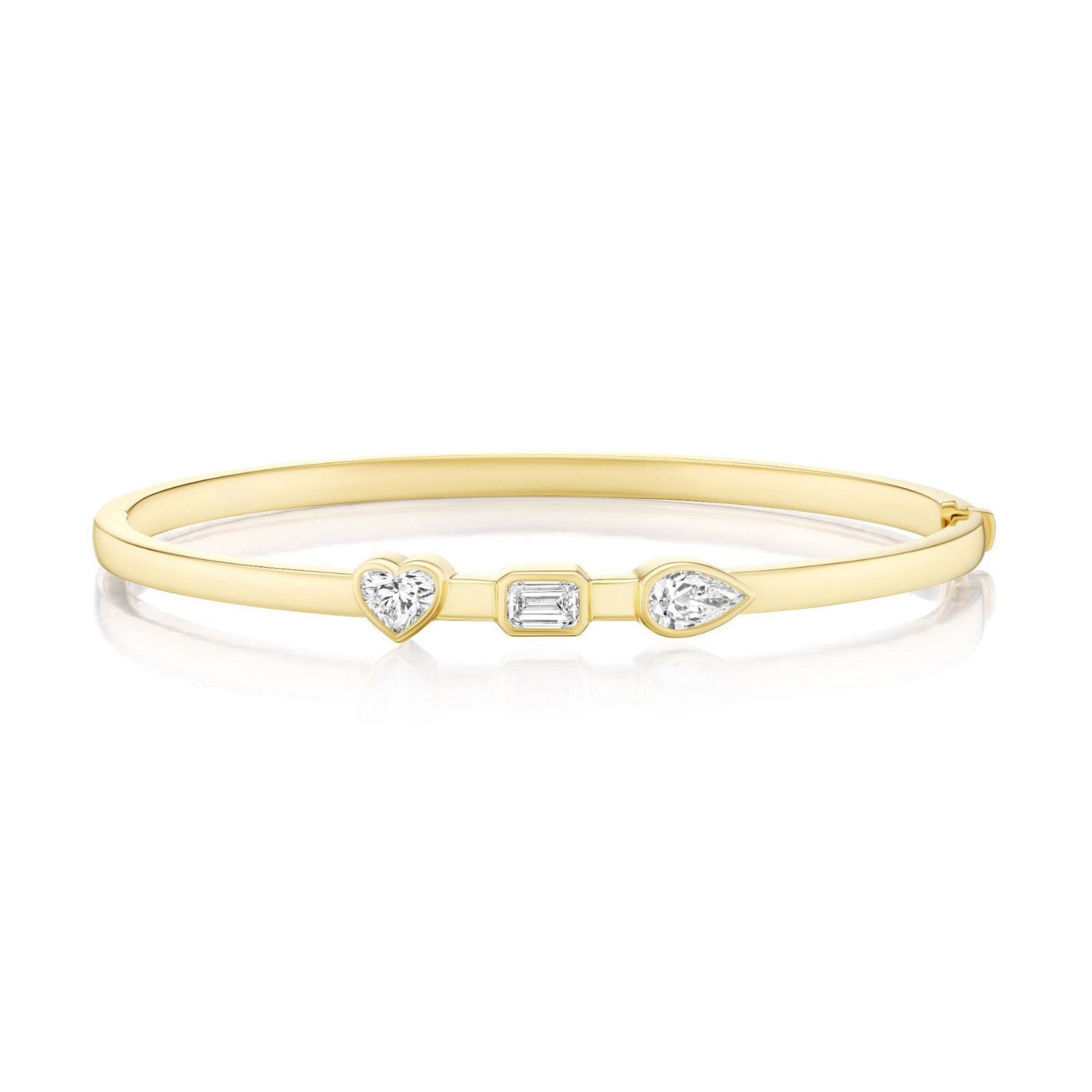 Introducing the Trio Bezel Set Mixed Shape Diamond Bangle in Yellow Gold—an elegant 18k gold bracelet showcasing a heart-shaped, an emerald-cut, and a pear-shaped diamond bezel-set at its center.