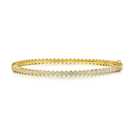 Hexagon Bezel Set Diamond Bangle: An elegant 18k gold bangle featuring a single row of round brilliant diamonds, each set closely together in hexagon bezels for a distinctive modern look.