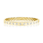 Introducing the Alternating Burnish Set Emerald Cut Diamond Bangle in Yellow Gold—a stunning 18k yellow gold bangle bracelet showcasing emerald cut diamonds, artfully burnish-set in an alternating pattern around the exterior, and finished with a sophisticated quilted inner design.