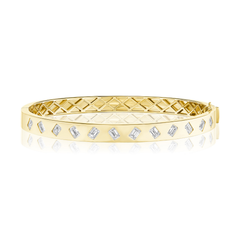 Introducing the Alternating Burnish Set Emerald Cut Diamond Bangle in Yellow Gold—a stunning 18k yellow gold bangle bracelet showcasing emerald cut diamonds, artfully burnish-set in an alternating pattern around the exterior, and finished with a sophisticated quilted inner design.