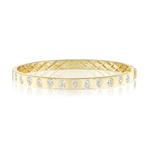 The Burnish Set Alternating Pear Shape Diamond Bangle in Yellow Gold features a quilted interior and a row of SI+ clarity, pear-shaped diamonds set evenly along its outer surface.