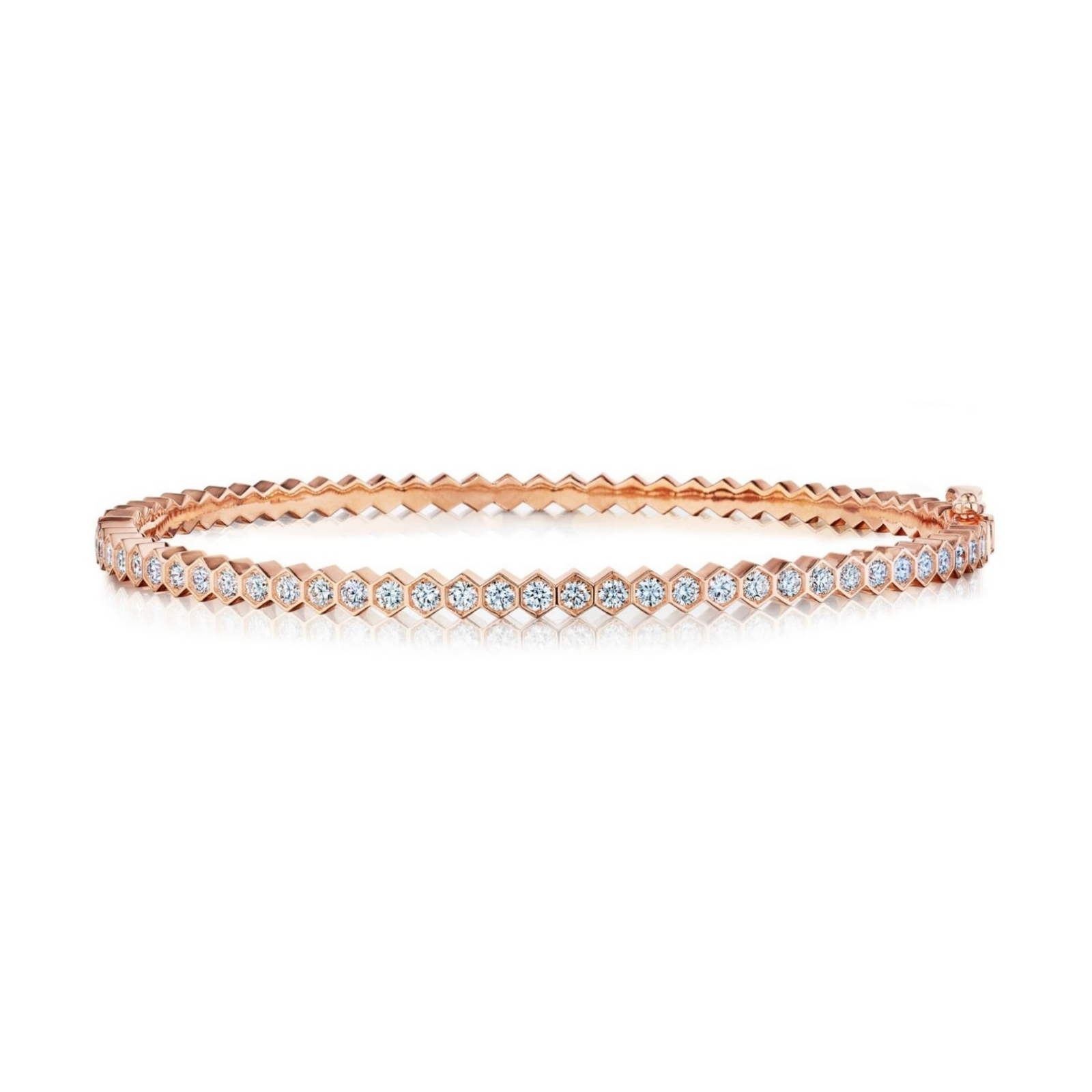 The Hexagon Bezel Set Diamond Bangle is a slim 18k gold bracelet adorned with a single row of round brilliant diamonds set in bezels, featuring a distinctive hexagonal pattern along the inner edge.