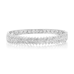 Chevron Baguette Diamond Bangle in White Gold featuring a geometric zigzag pattern and a reflective surface, displayed on a white background.