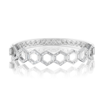 The Chrysler Hexagon Bangle with Baguette Diamonds is a silver bracelet showcasing a geometric hexagon pattern inspired by the iconic design, adorned with clear gemstones and exquisite baguette diamonds arranged in a honeycomb motif, displayed on a reflective white surface.