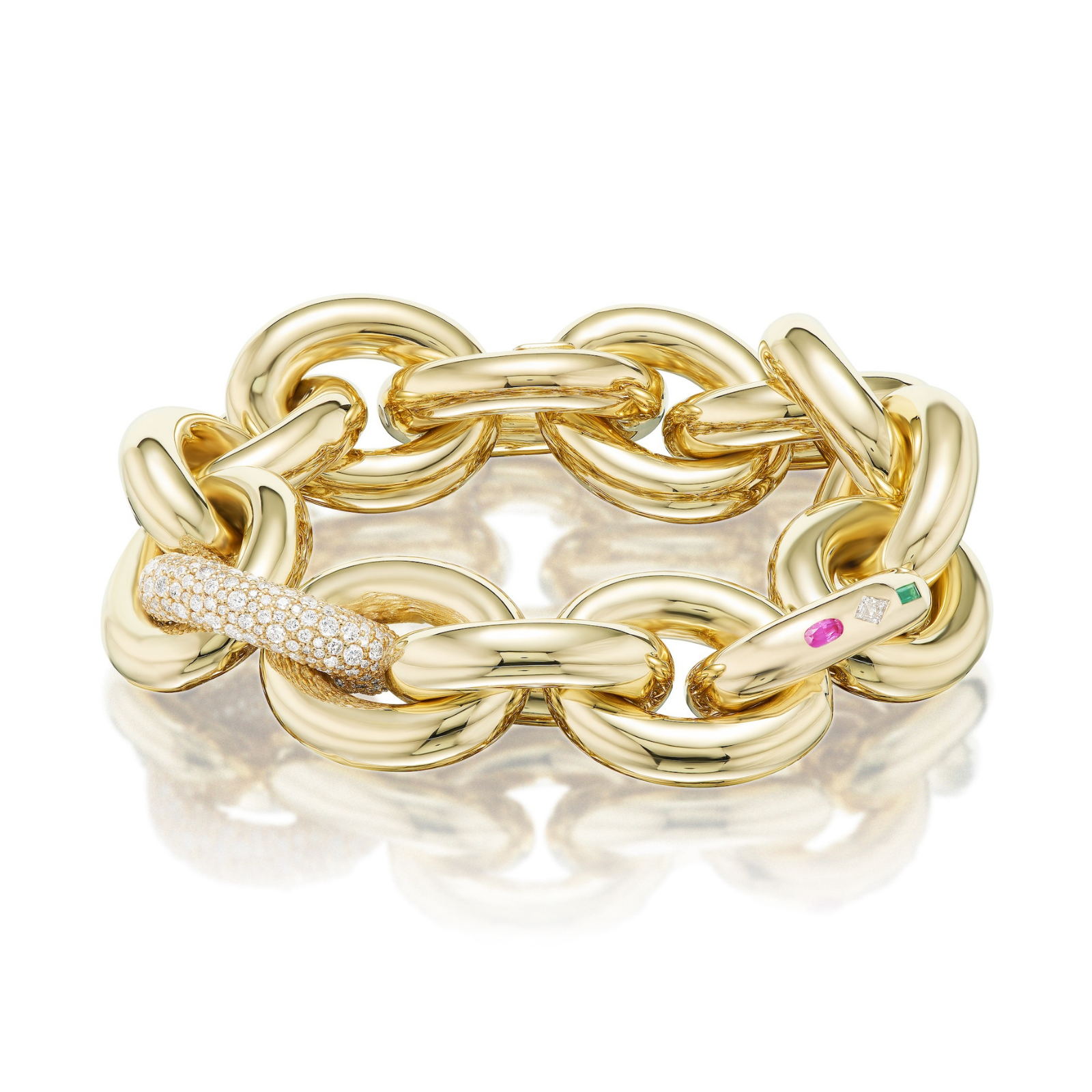 A chunky link bracelet crafted in 18K yellow gold, featuring oval links with one pavé-set diamond link and another accented with burnish-set sapphire and emerald stones.