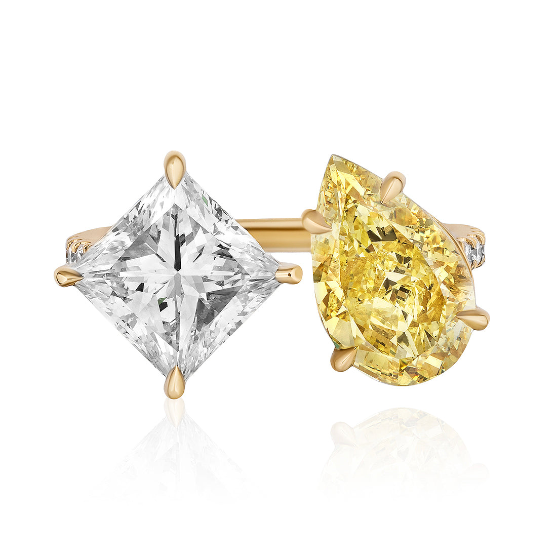 The Toi et Moi Pavé Ring features a white princess cut diamond and a fancy yellow pear-shaped diamond set side by side in gold prongs.