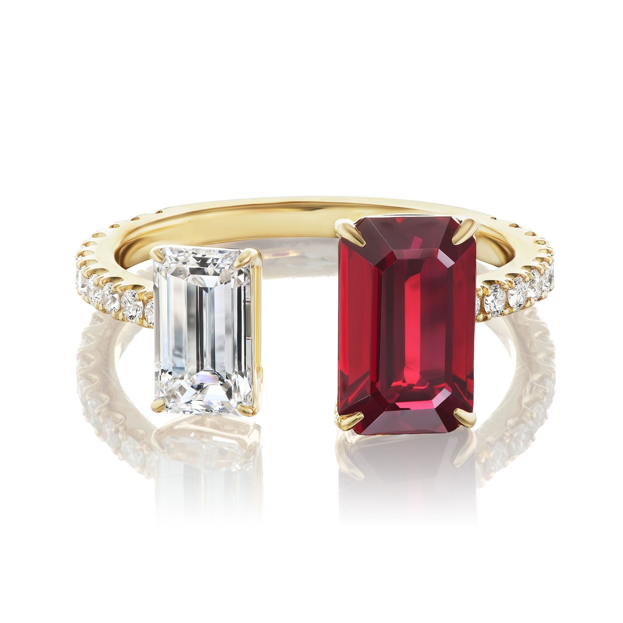 The Toi et Moi Pavé Ring features a row of pavé diamonds on an 18K yellow gold band, set with two emerald-cut stones—a diamond and a vivid ruby—displayed side by side.