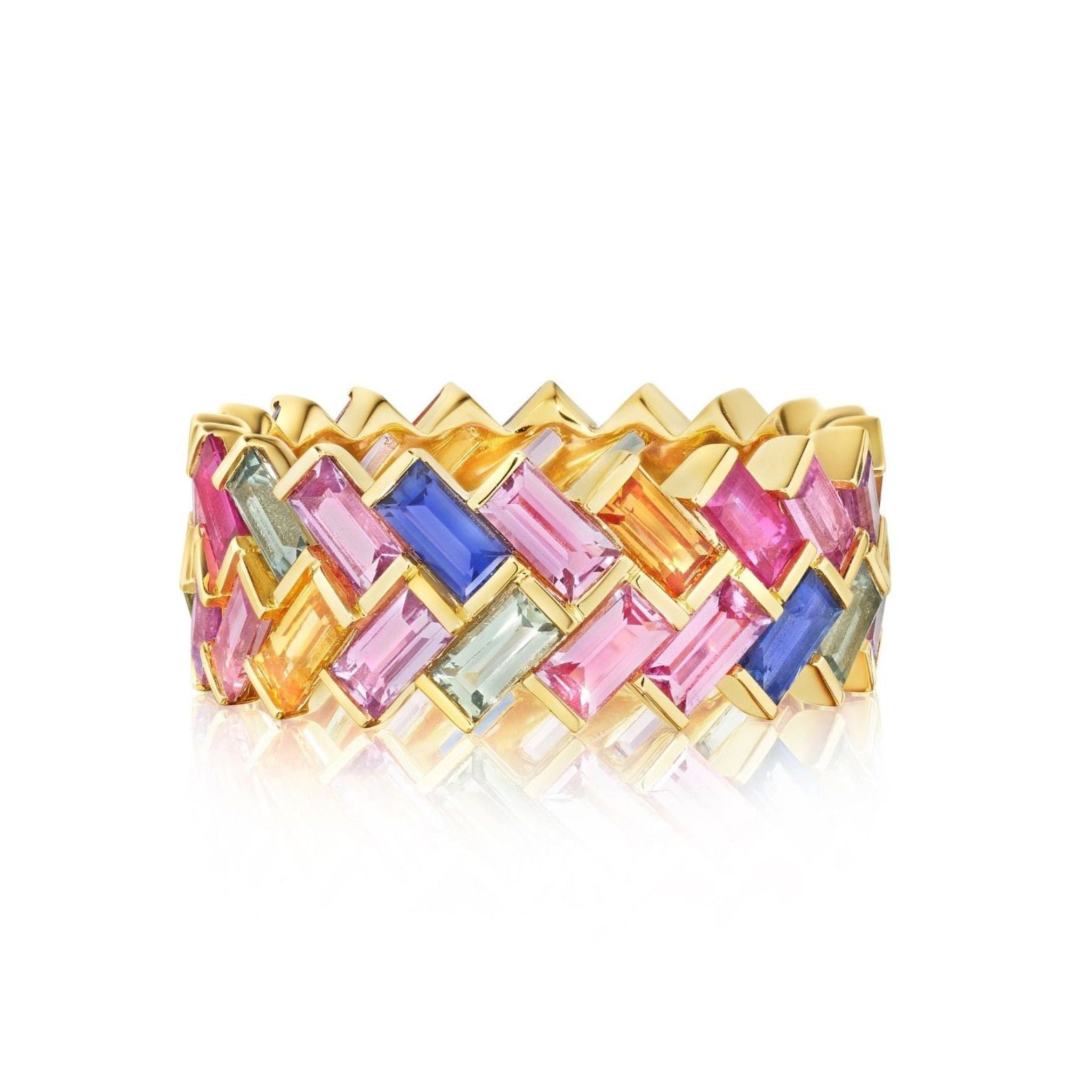 The Chroma Chevron Bezel Set Ring in 18K Yellow Gold showcases a woven chevron pattern with bezel-set multicolor baguette sapphires—pink, blue, yellow, green, and light purple.