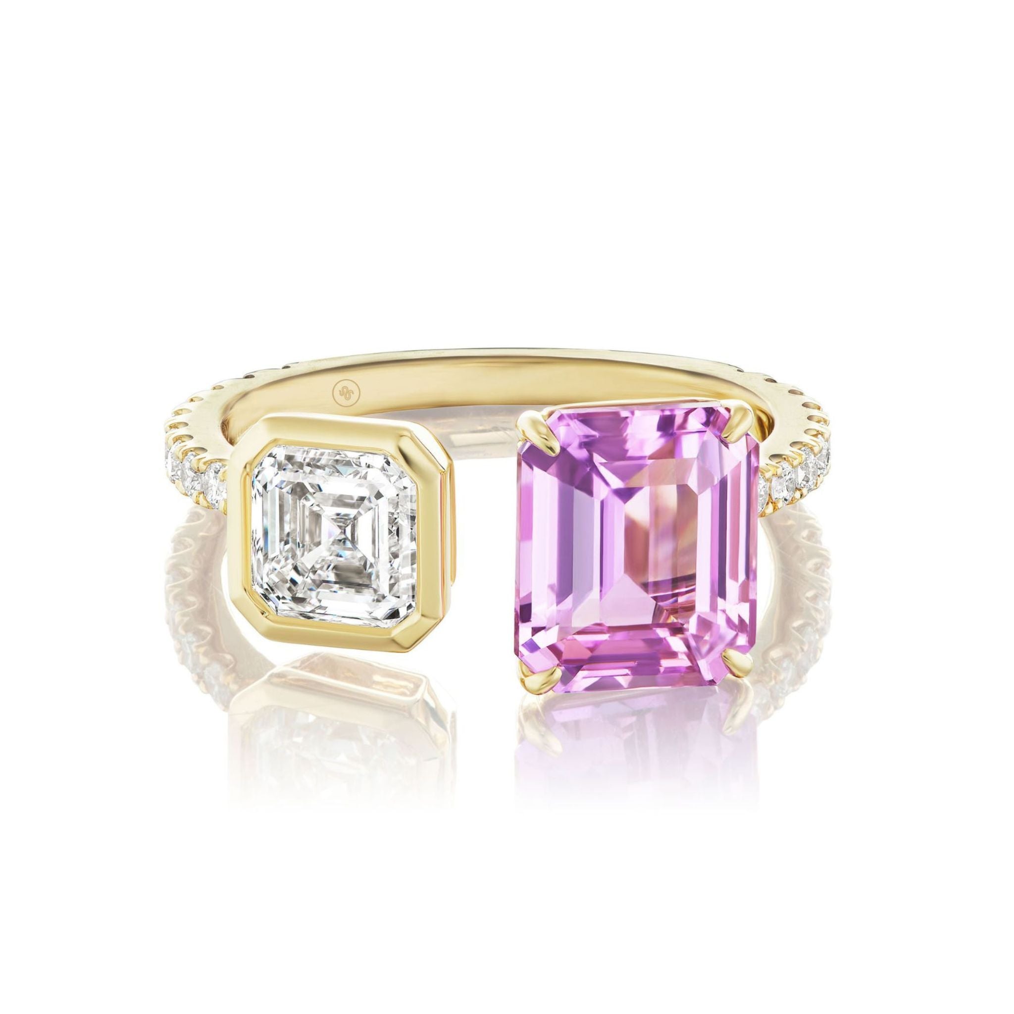 Introducing the Toi et Moi Pavé Ring, crafted in 18k yellow gold and showcasing a striking square emerald cut diamond paired side by side with a vibrant pink emerald cut sapphire. The delicately designed band is pavé-set with small round diamonds, adding an extra touch of brilliance to this exquisite piece.