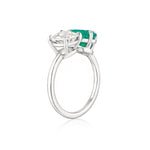 The Toi et Moi Pear Shape Emerald and Round Diamond Engagement Ring in White Gold showcases a pear-shaped emerald and a round diamond set side by side in elegant prongs against a white background.
