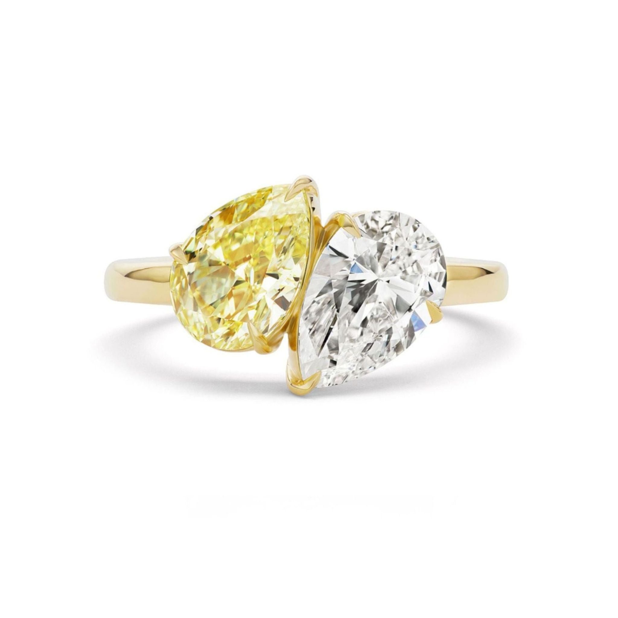 Introducing the Toi et Moi Ring with Fancy Yellow and White Pear Diamonds: a gold ring showcasing two pear-shaped gems—one fancy yellow diamond and one white diamond—set side by side in an elegant bypass style, making it the perfect choice for those seeking a unique engagement ring or a dazzling bridal piece.