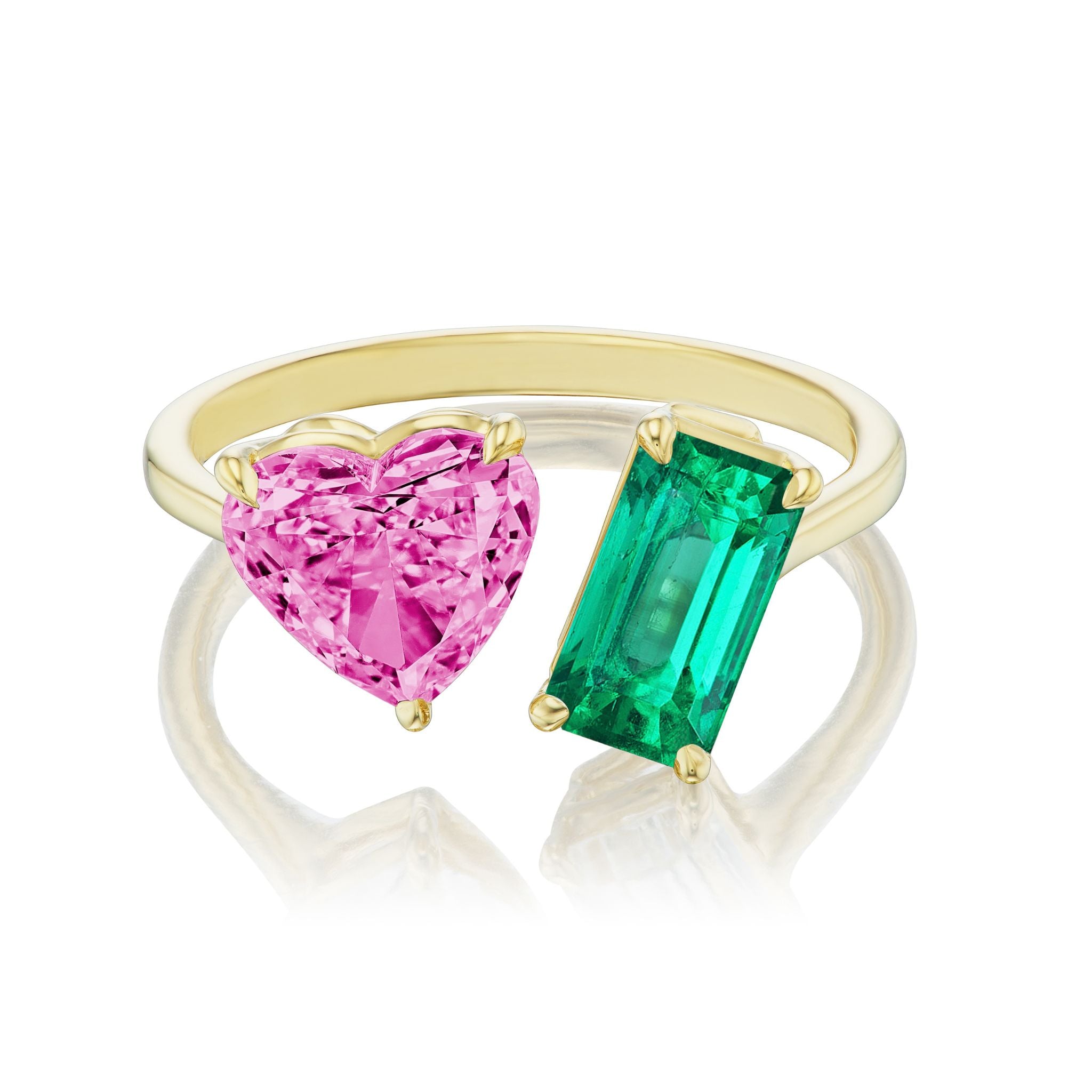 The Toi et Moi Ring features a pink heart sapphire and an emerald cut emerald set side by side in 18K yellow gold.