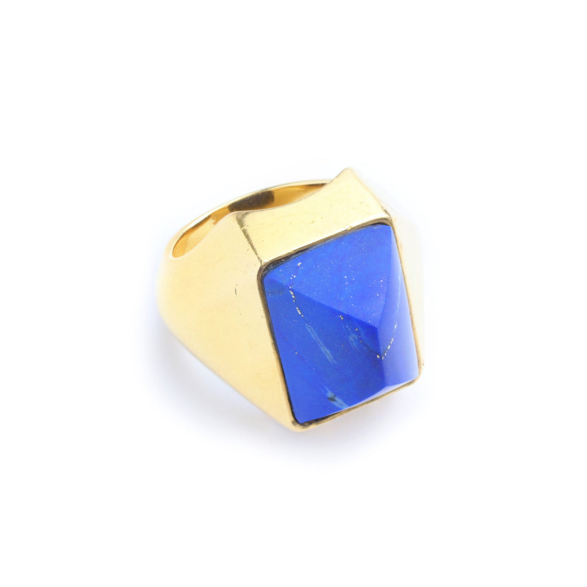 The Boucheron Lapis Lazuli and Gold Ring features a large, rectangular blue lapis gemstone with a faceted surface, set in a modern angular gold design and photographed against a white background.