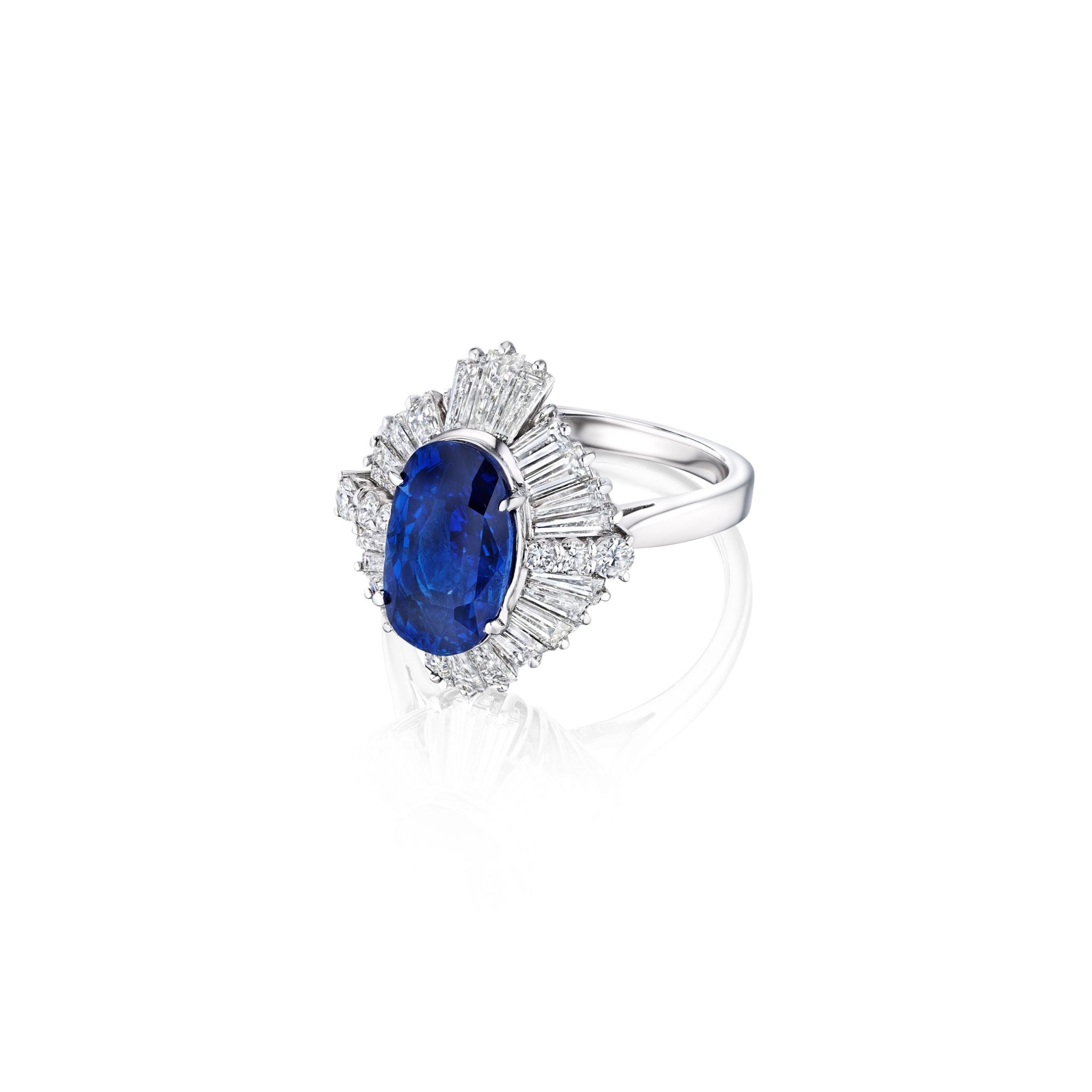 The Sapphire and Diamond Ring features a large oval Ceylon sapphire set in platinum, accented by baguette and round white diamonds in a striking starburst design.
