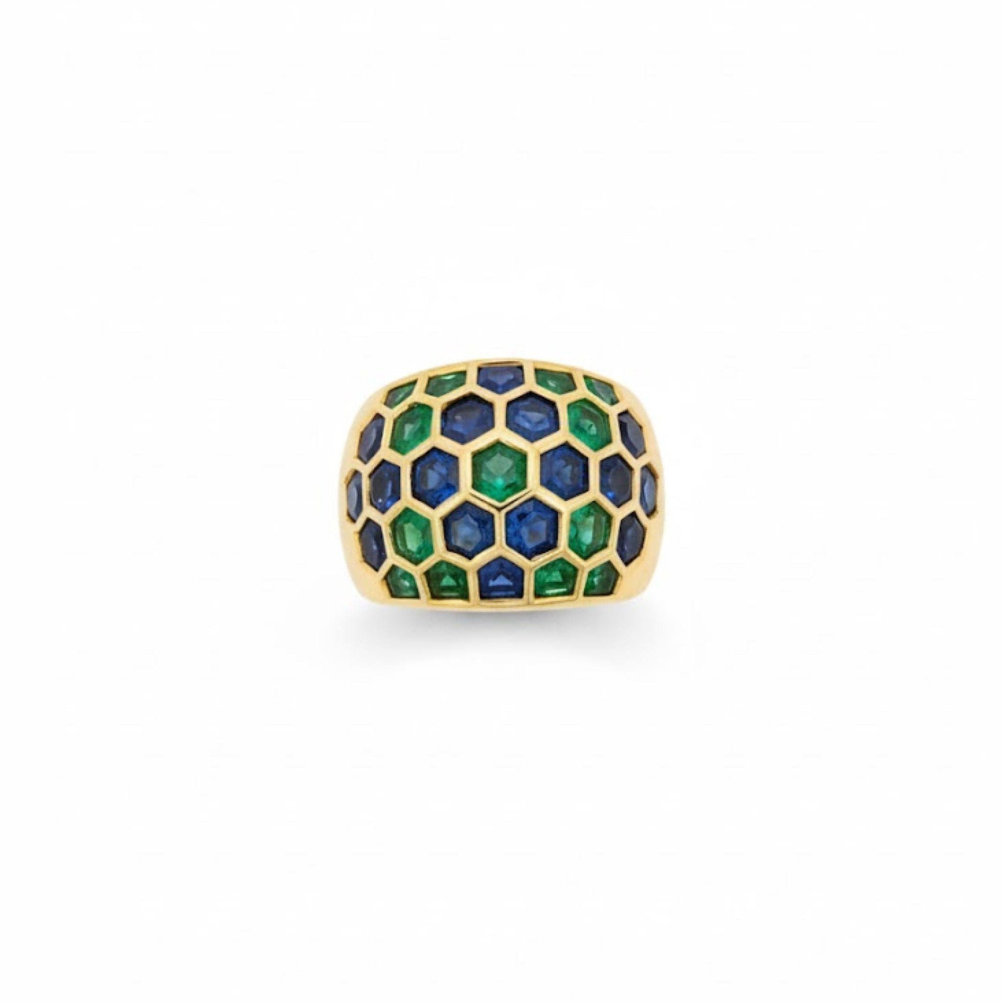 The Sabbadini Emerald and Sapphire Ring is crafted in 18K yellow gold with alternating sapphire and emerald gemstones set in each hexagonal cell, displayed on a plain white background.