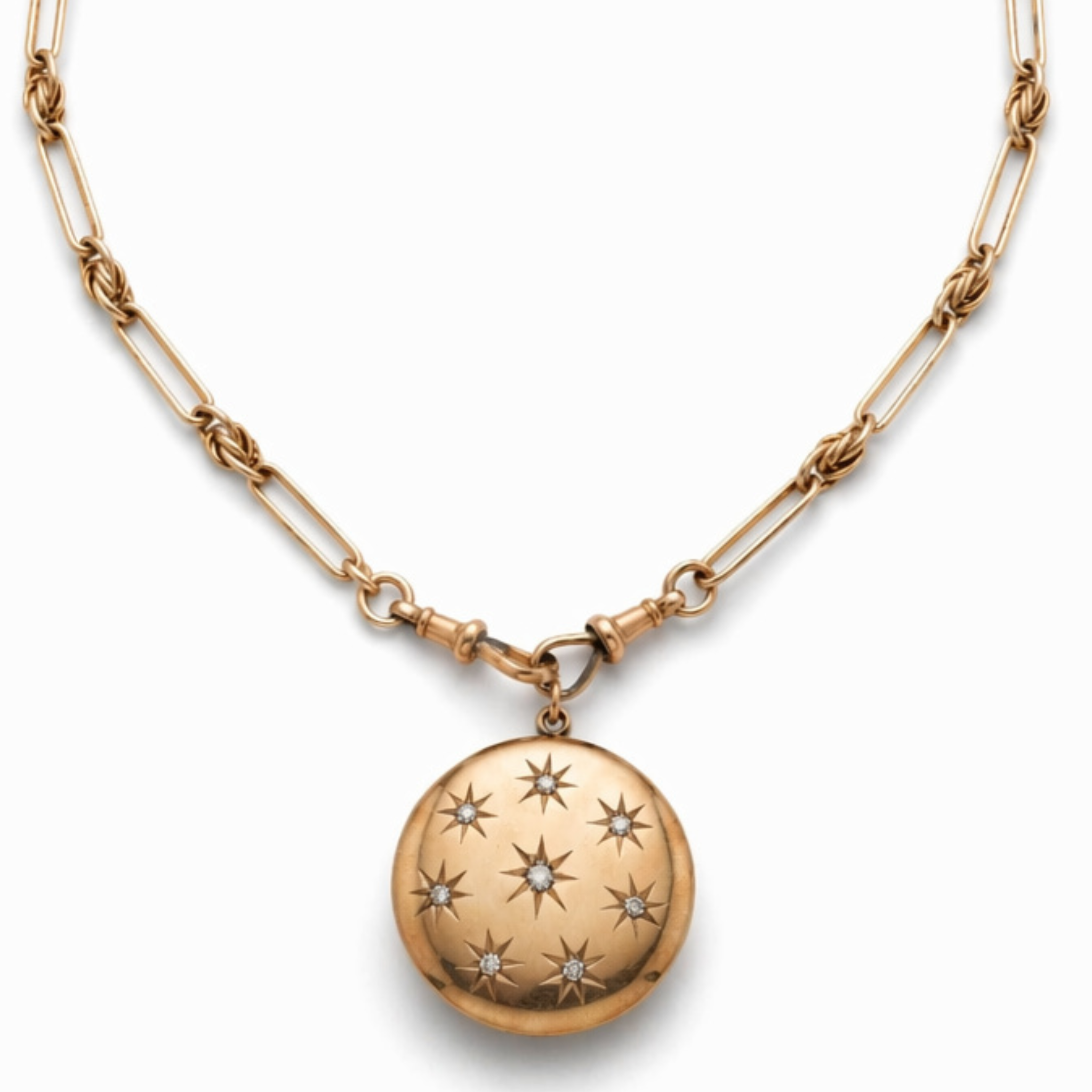 The Antique Gold Watch Chain and Victorian Locket features a 14K rose gold chain with an oval antique locket, adorned with seven diamond-shaped stars, each set with a tiny gemstone at its center.