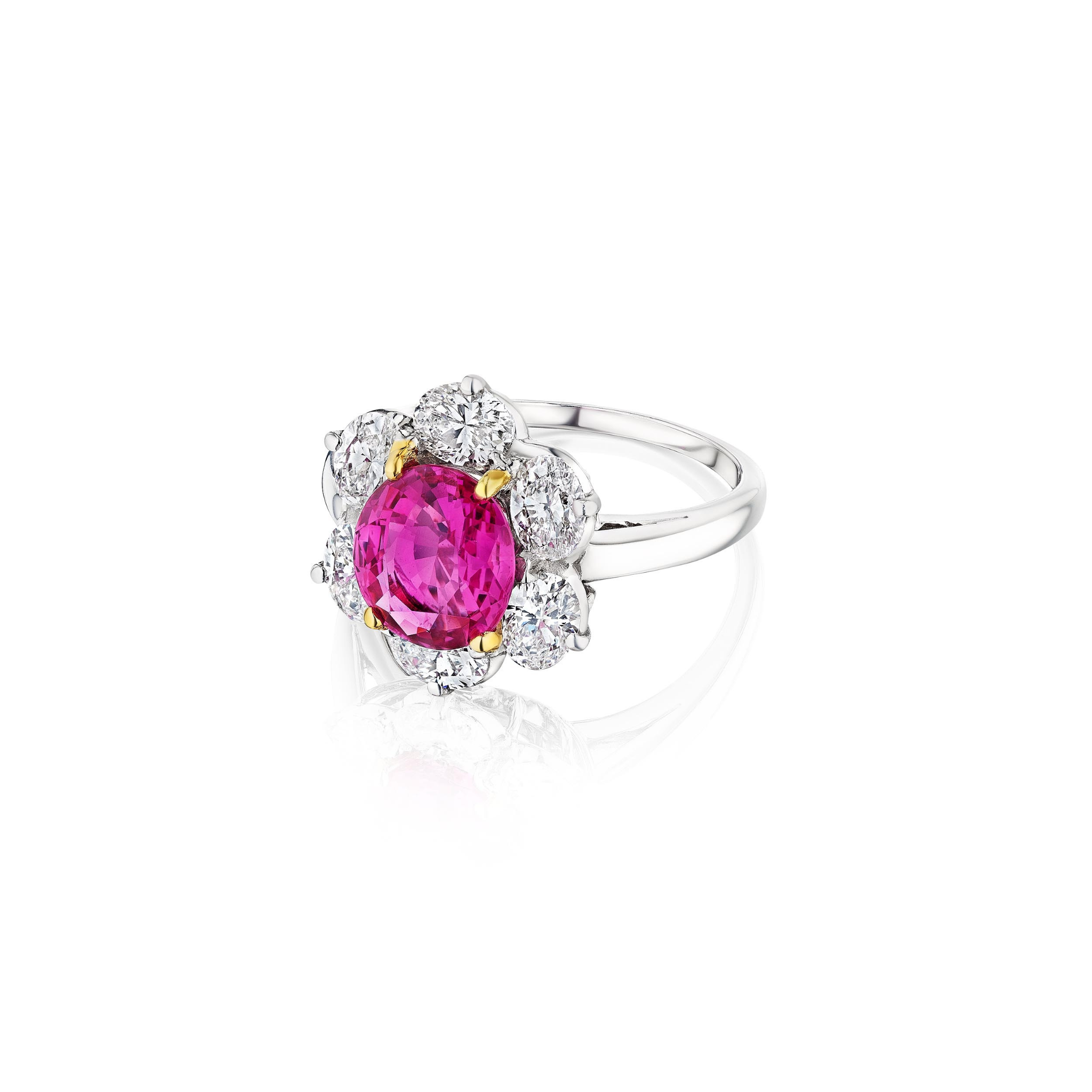 The Oscar Heyman & Brothers Pink Sapphire and Diamond Ring features a large round pink sapphire at the center, encircled by a floral pattern of sparkling white diamonds set in platinum and white gold.