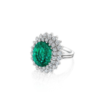 Introducing the Vintage Emerald and Diamond Ring: an exquisite 18K white gold piece showcasing a striking oval Colombian emerald at its center, elegantly encircled by two rows of dazzling round diamonds in a sophisticated floral halo setting.