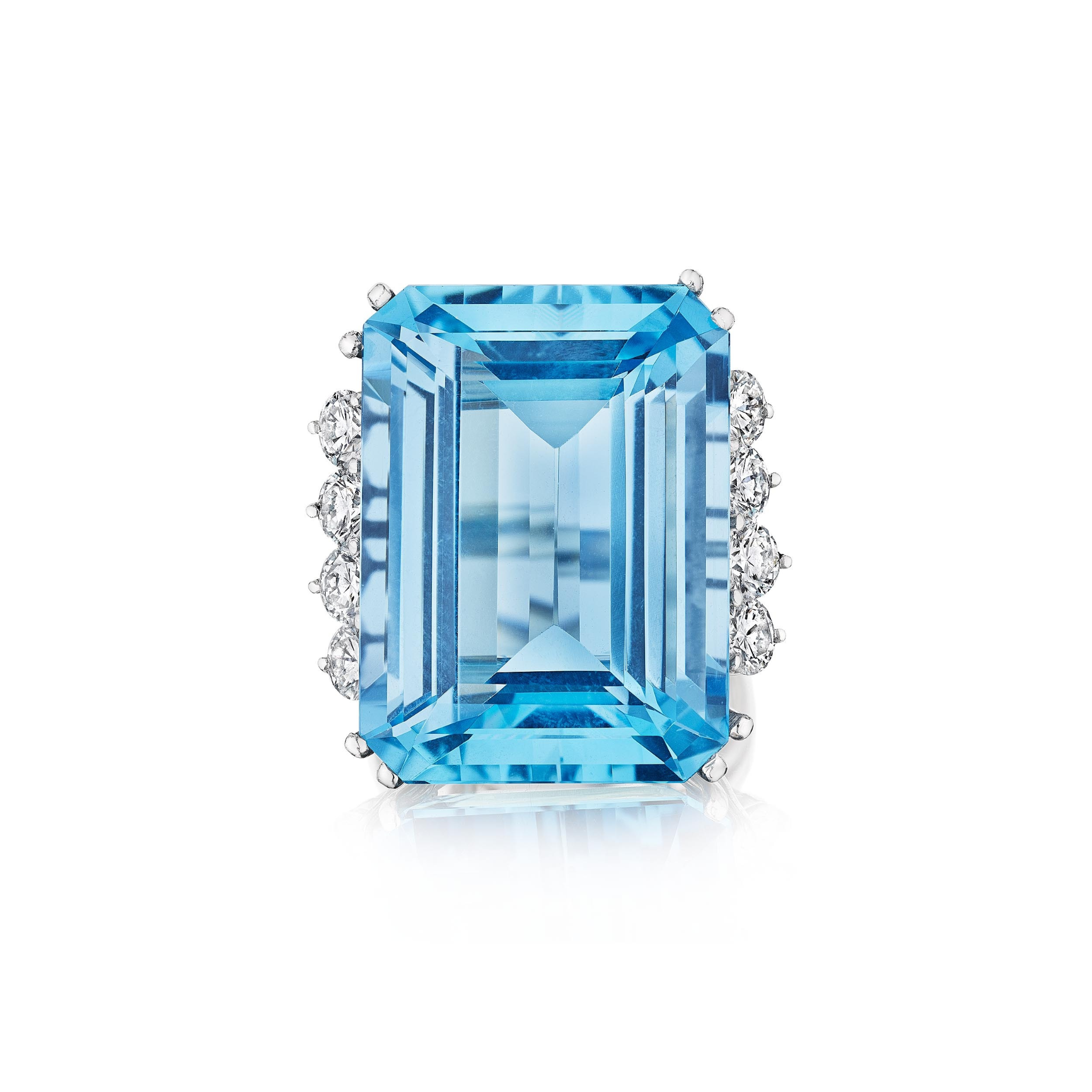 The Aquamarine and Diamond Ring features a rectangular emerald-cut aquamarine flanked by small round diamonds on each side, all set in a polished platinum band and shown on a white background.