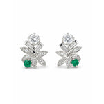 A pair of emerald and diamond earclips in 14K white gold, showcasing a vintage 1960s-inspired floral design with round emerald accents and sparkling white diamonds in petal motifs.