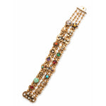 The Colored Stone and Diamond Bracelet is a striking 14K yellow gold piece with round and oval settings, colored stones, pearls, diamonds, and ornate details arranged in three parallel rows—a standout vintage design.