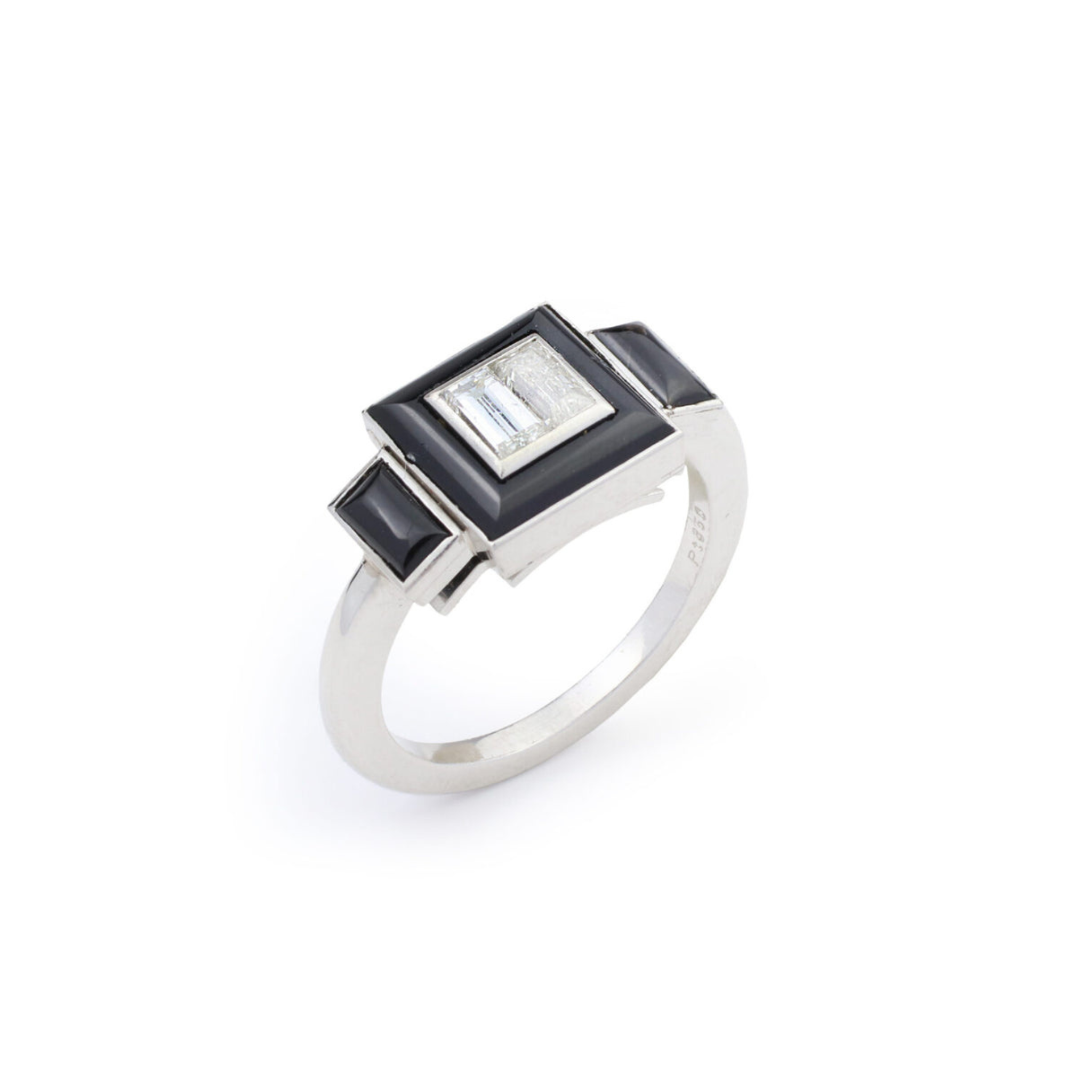 The Vintage Onyx and Diamond Ring features a rectangular clear diamond at its center, framed by striking black onyx accents on a plain platinum band, displayed against a white background.
