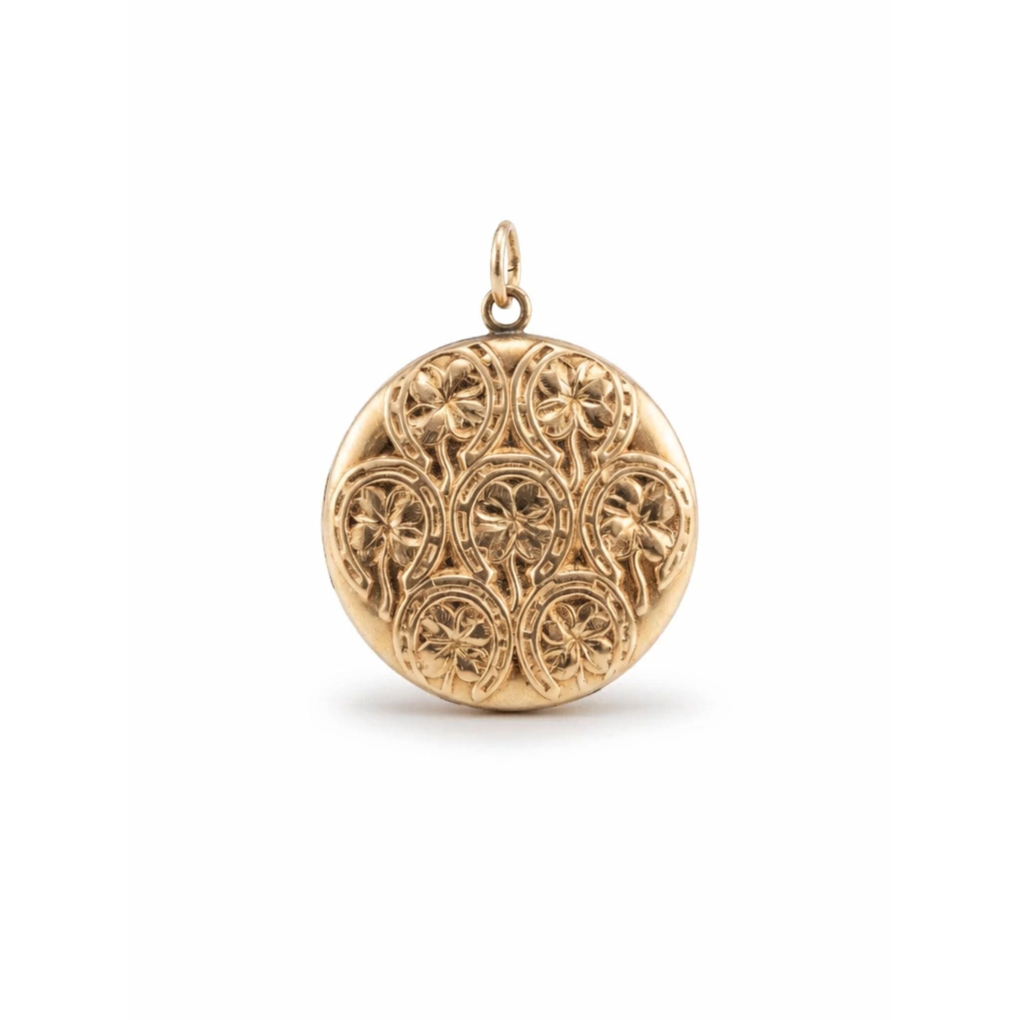 The Victorian Horseshoe and Clover Engraved Gold Locket is a round gold antique locket with ornate, repeating floral and circular patterns, featuring a small top loop for attaching to a chain.