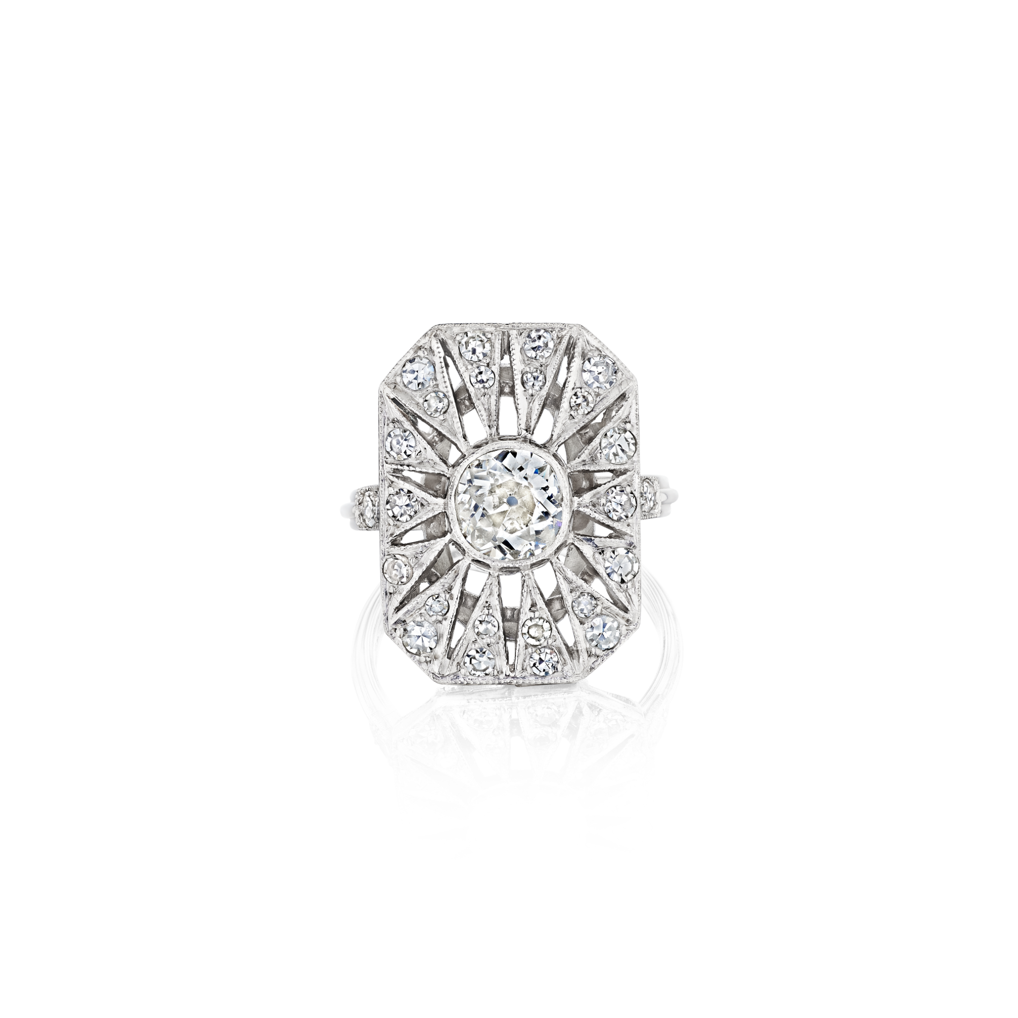 The Art Deco Diamond Ring is a platinum silver piece with a rectangular design, showcasing an old European-cut center diamond, radiating lines, and smaller old-cut diamonds on a white background.
