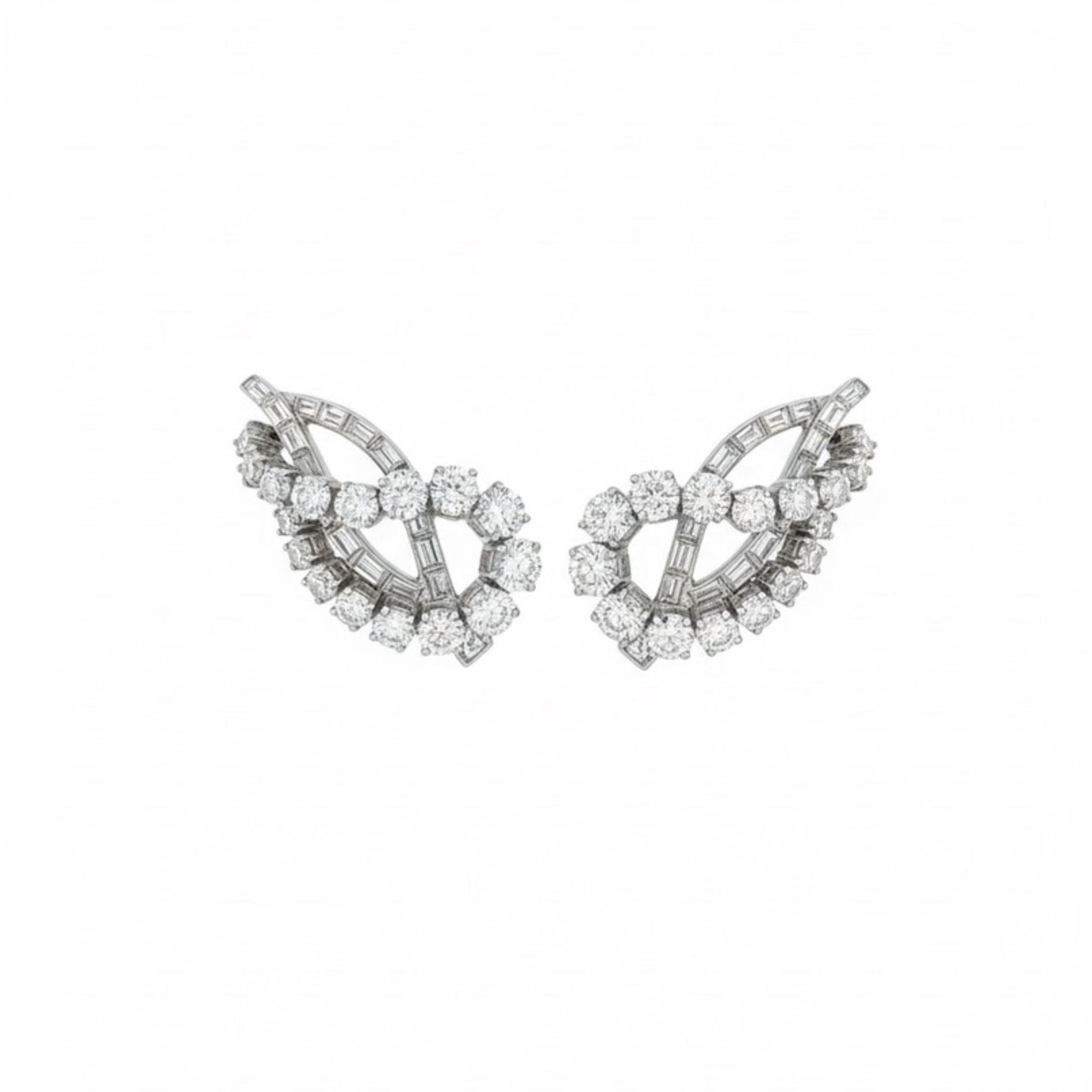 A pair of Diamond Earclips featuring a leaf-inspired design with clusters of round and baguette-cut diamonds set in platinum, shown against a plain white background.