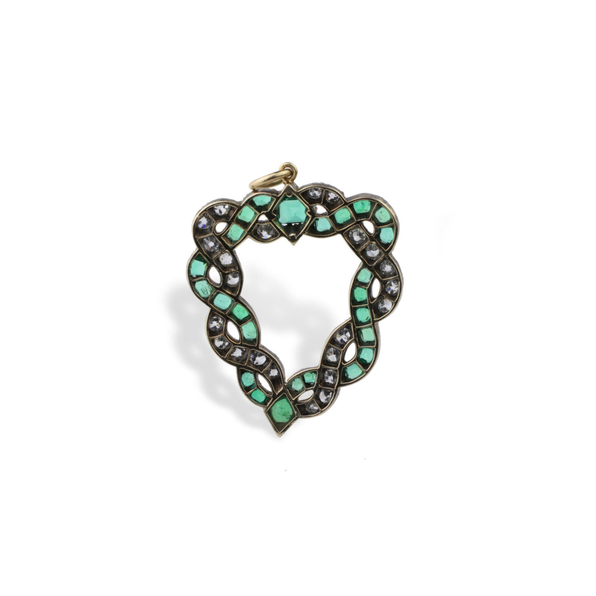 The Emerald and Diamond Pendant features interwoven cushion-shaped emeralds and old-cut diamonds in a gold heart-shaped frame, finished with a top loop for chains—a refined homage to classic antique heart brooches.