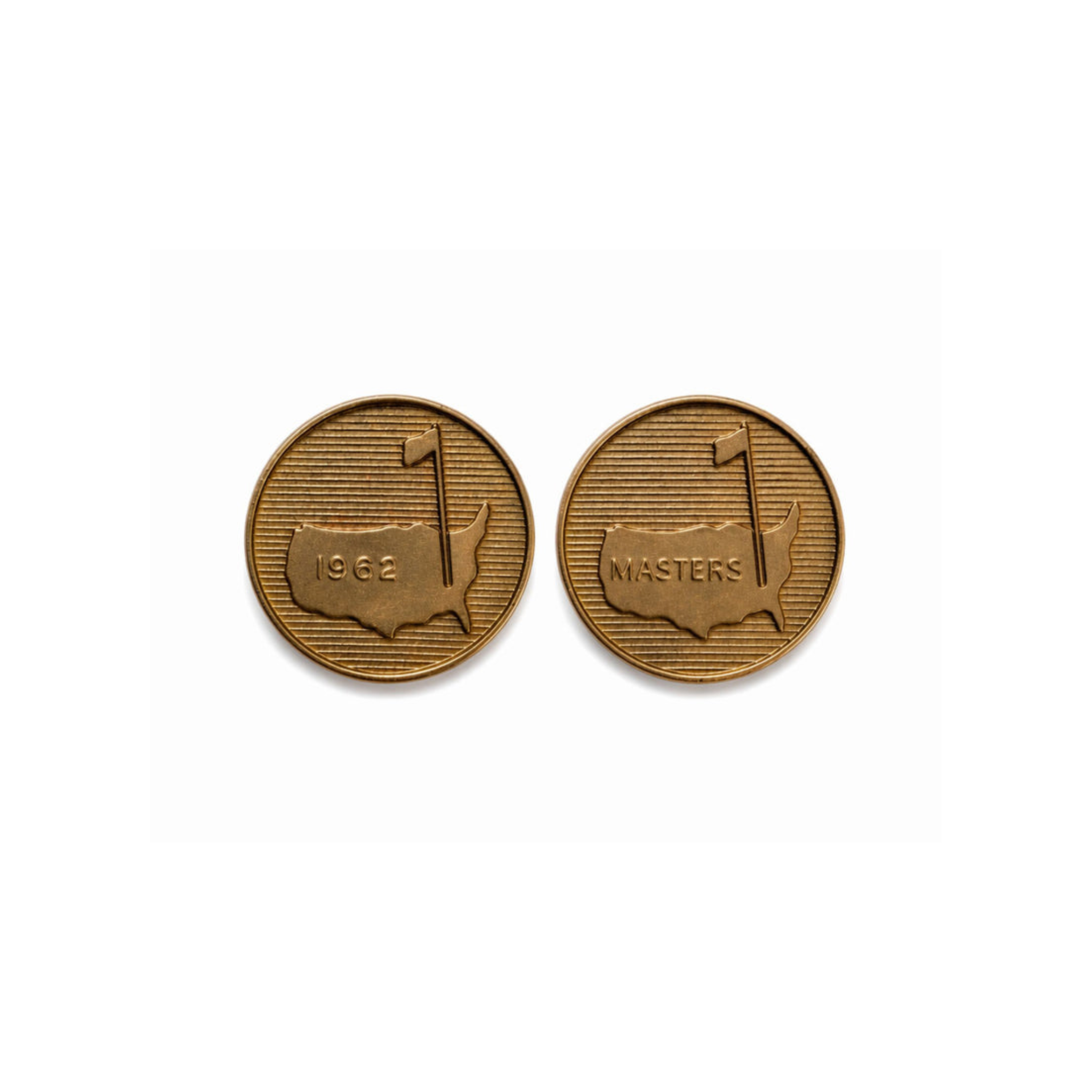 A pair of gold "Masters" cufflinks feature an outline of the U.S. with a golf flag—one engraved 1962, the other MASTERS—both commemorating the U.S. Masters Tournament against lined backgrounds.
