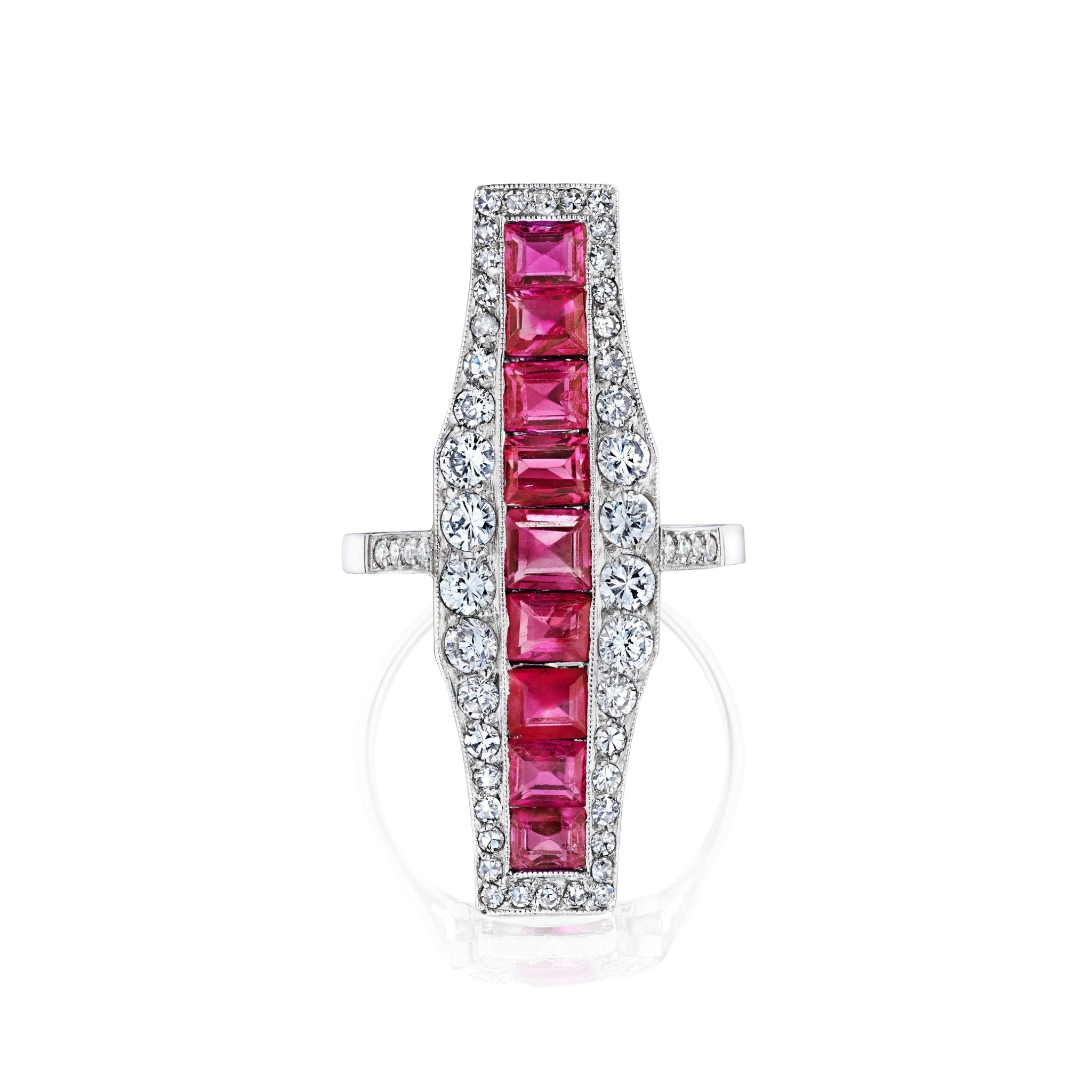 The Ruby and Diamond Ring showcases a vertical row of nine square-cut rubies, flanked by two rows of round old European diamonds in a rectangular, intricately detailed silver setting.