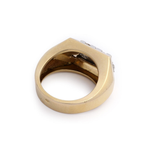 A Mauboussin Gold and Diamond Ring, circa 1940, featuring a thick band and a flat top, is viewed from above at an angle, revealing the inside of the band and part of its setting.