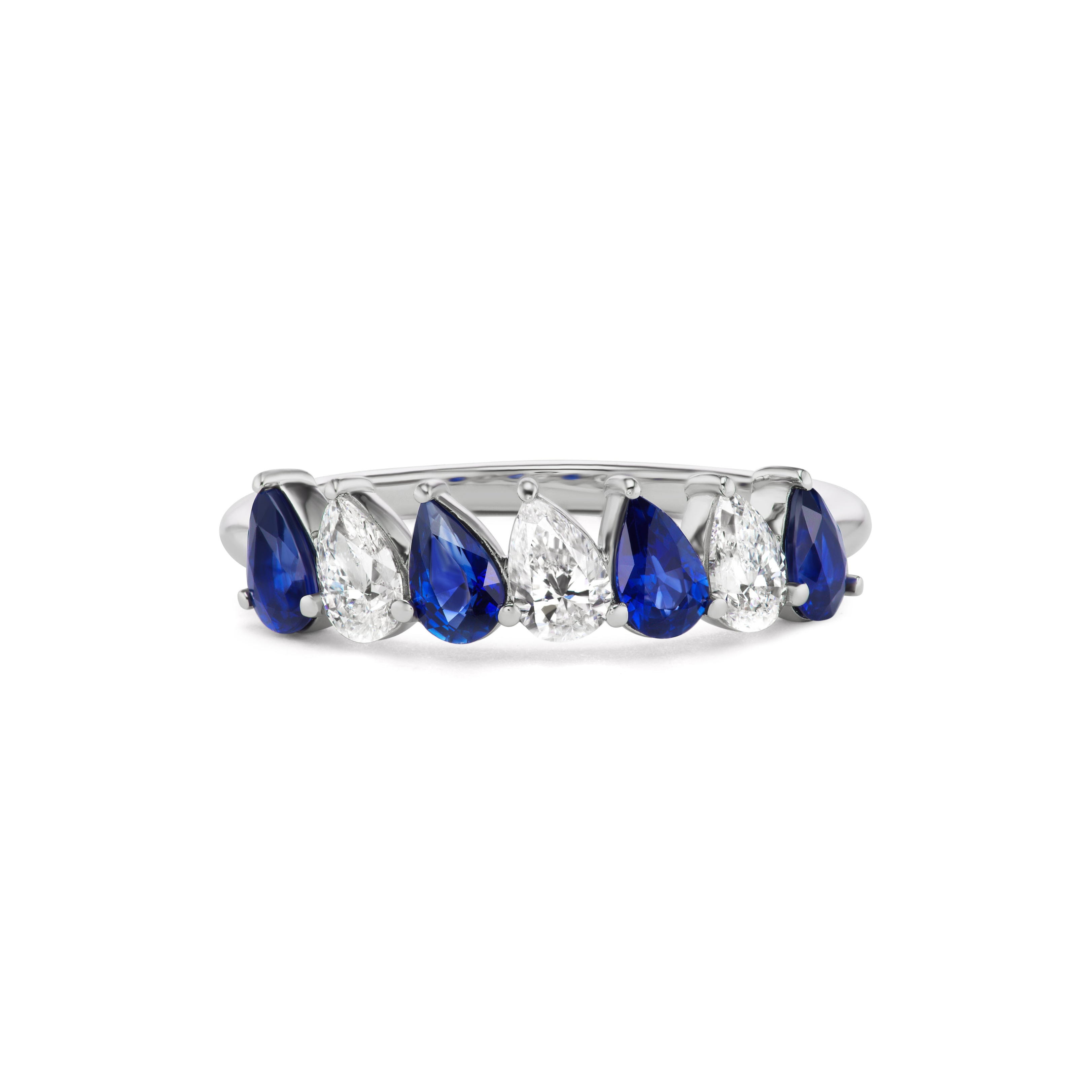 The Diagonal Pear Eternity Band features alternating pear-shaped blue sapphires and diamonds, elegantly set in a row of gleaming 18K white gold.