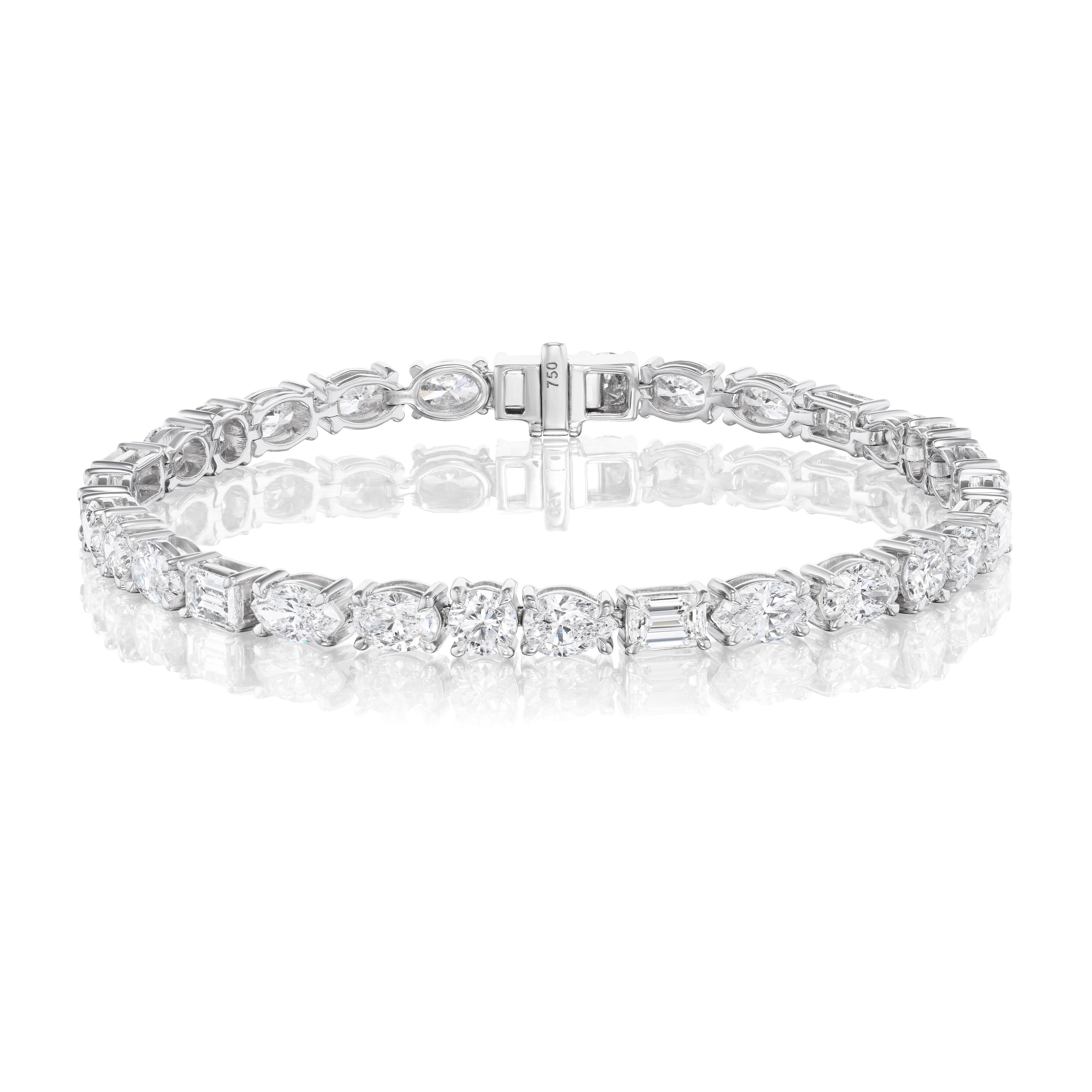 The Medium East-West Mixed Shape Diamond Tennis Bracelet in 18k white gold features alternating oval, marquise, emerald, and round diamonds, shown on a plain white background with a reflective surface.