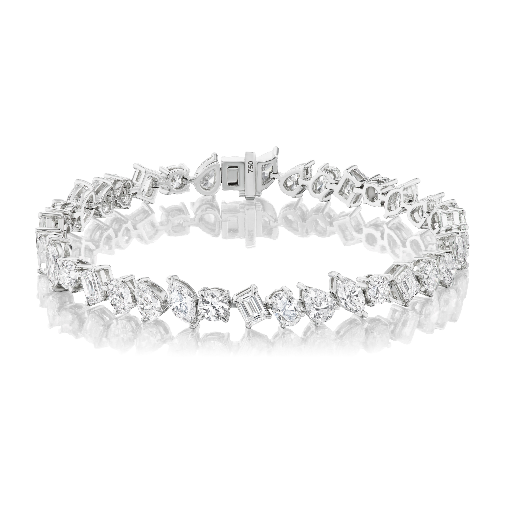 The Mixed Shape Diamond Tennis Bracelet in 18k white gold features alternating diamond shapes and a secure clasp, showcased on a reflective white surface.