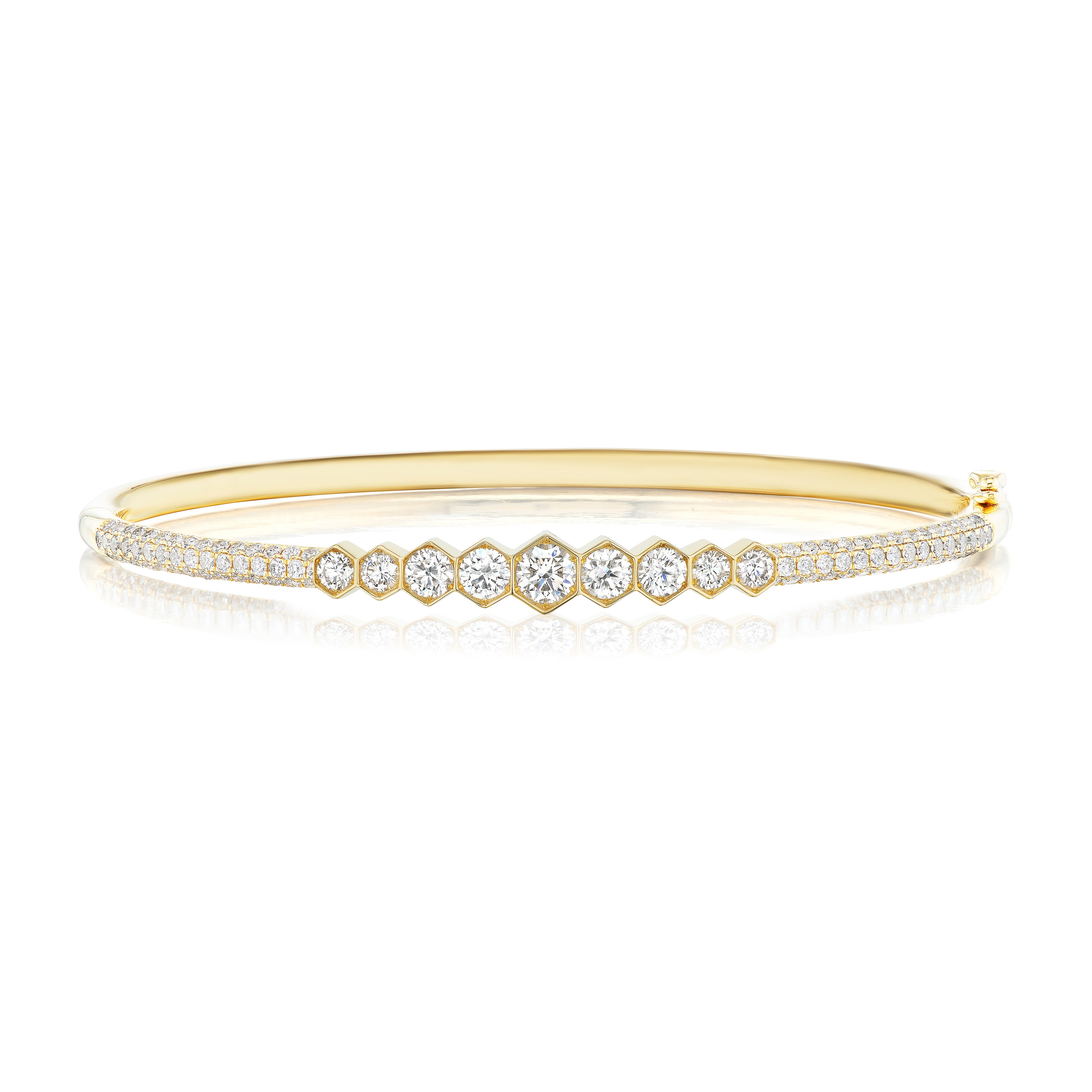 The Graduated Hexagon Bezel Set Diamond Bangle with Pavé features round diamonds in graduated sizes, framed by pavé accents—a stunning 18K gold bracelet perfect for any occasion.