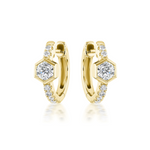 The Pavé Huggies with Hexagon Bezel Set Diamonds are 18K gold hoops featuring central round diamonds in hexagon settings and pavé diamond accents along the front, shown on a white background.