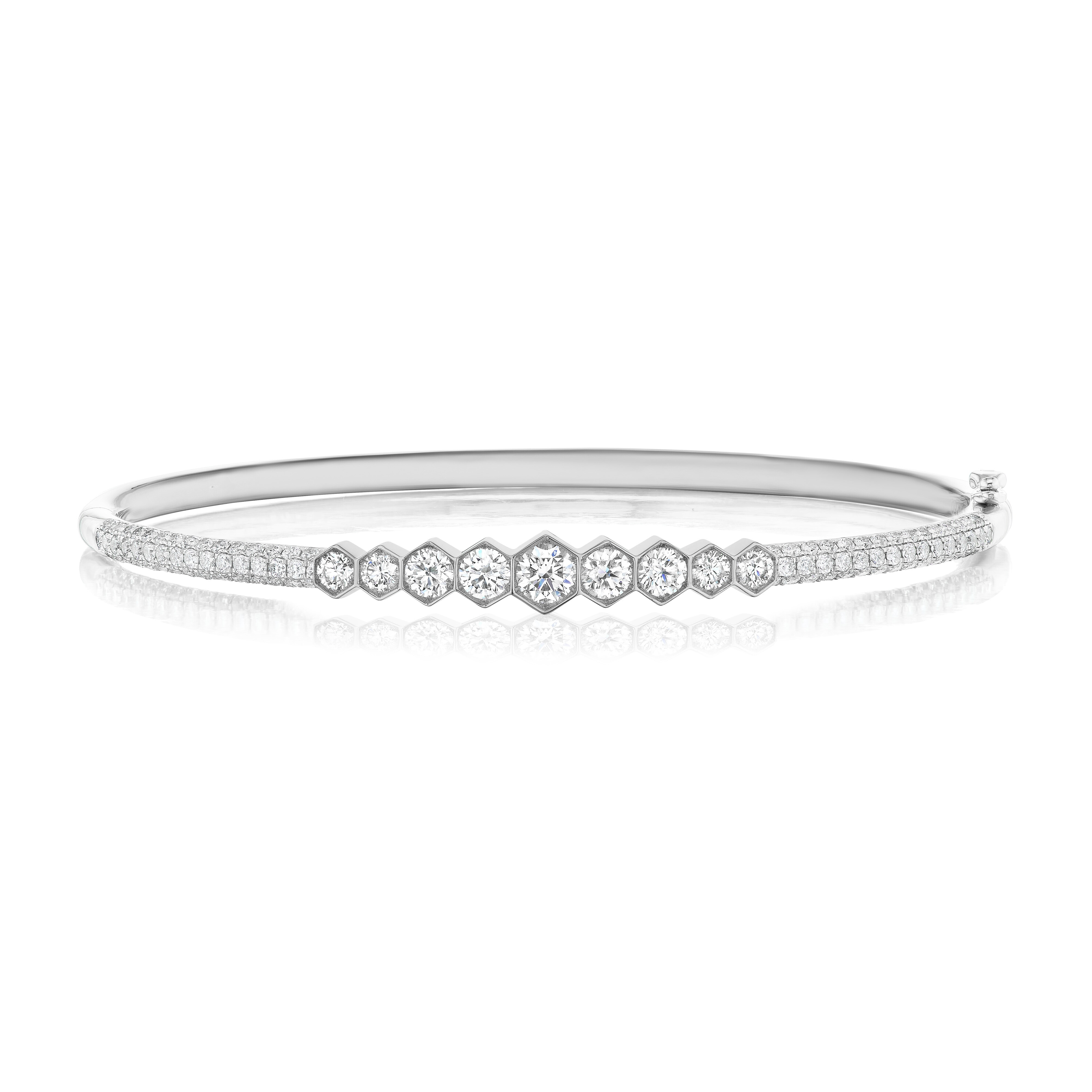 An elegant Graduated Hexagon Bezel Set Diamond Bangle with Pavé, featuring a center row of diamonds that decrease in size toward the edges, outlined by sparkling pavé diamonds for a refined update to the classic design.