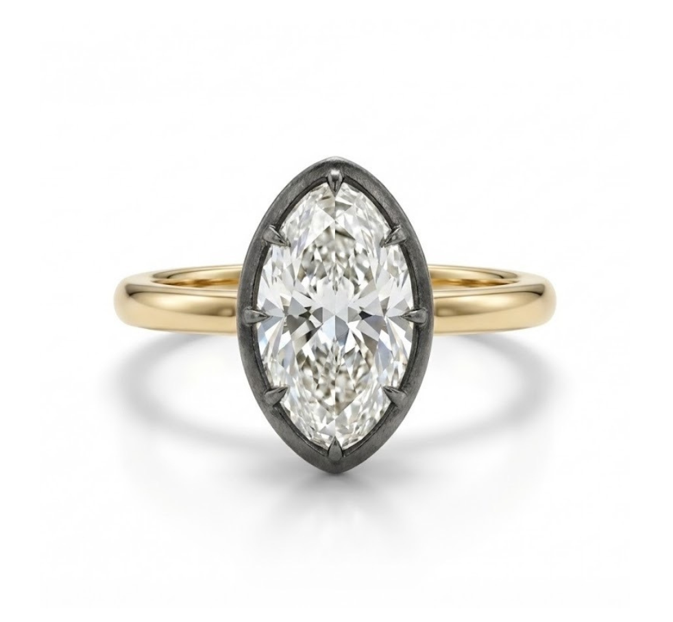 The Collet Set Marquise Diamond Solitaire Ring in Black Rhodium and Yellow Gold showcases a clear marquise-cut diamond in an elegant black rhodium oval prong setting against a white background.