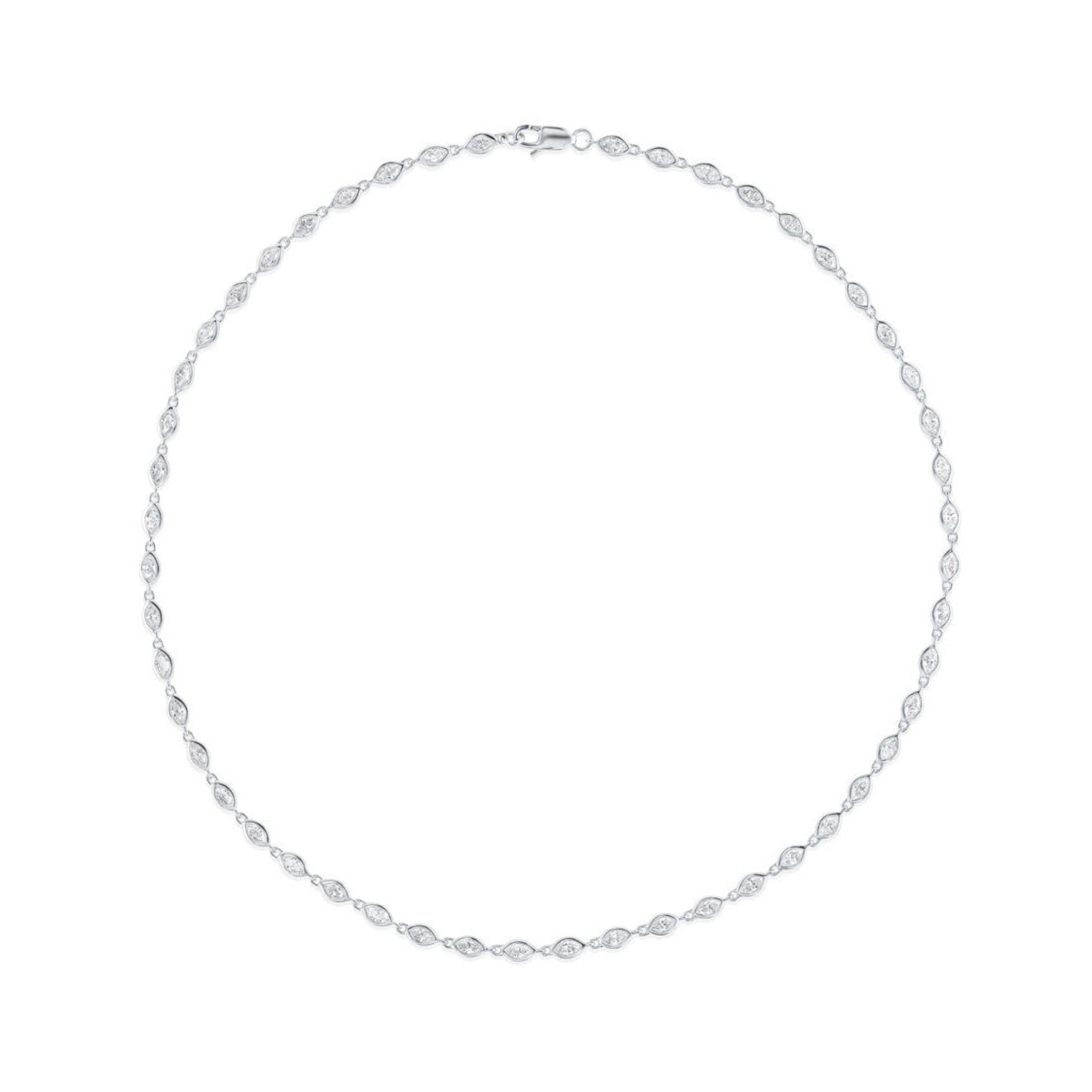 The Chasing Marquise Tennis Necklace is crafted in 18K white gold, showcasing evenly spaced oval links, each set with clear crystals in a symmetrical circle and finished with a top clasp.