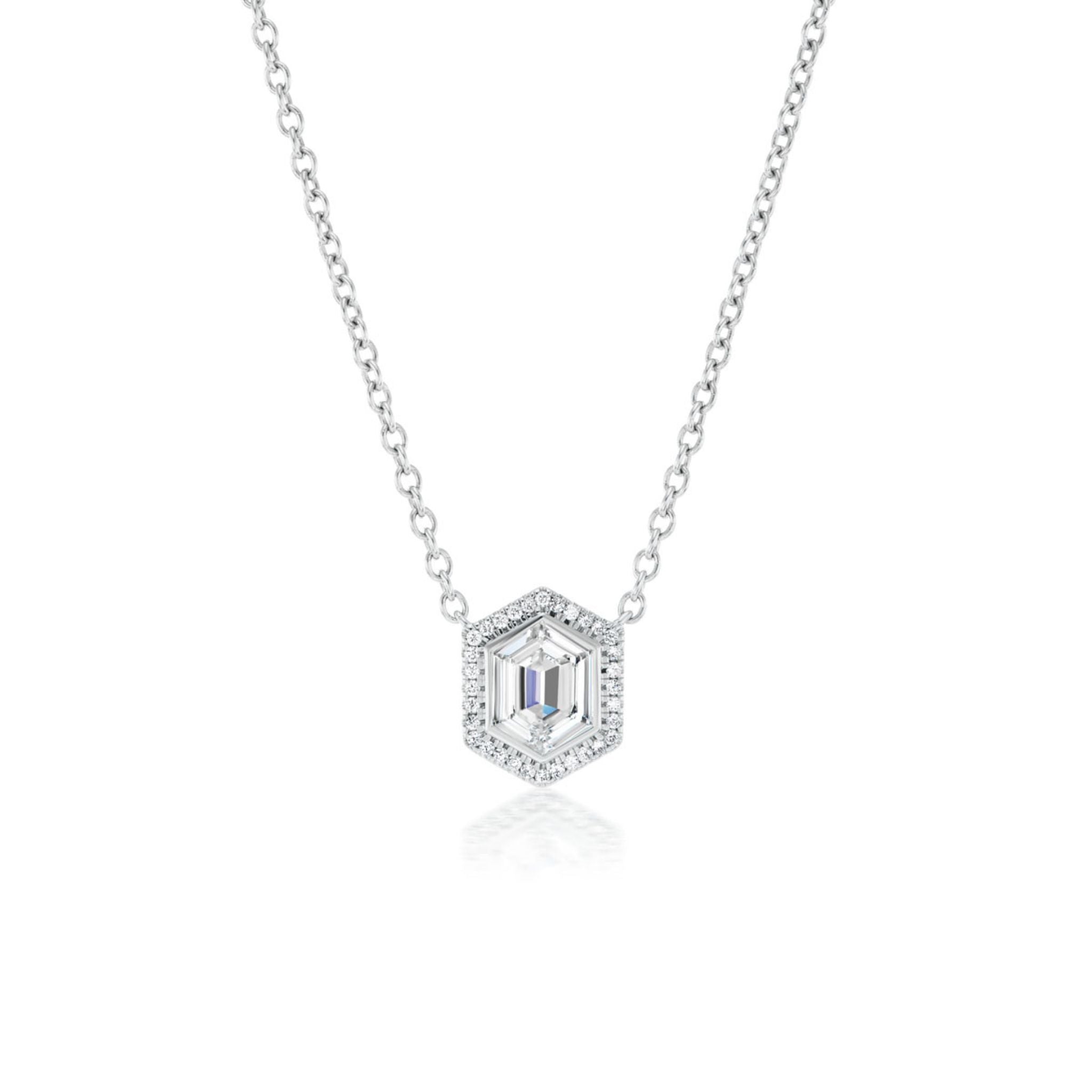 The Pavé Hexagonal Diamond Solitaire Pendant in White Gold showcases a central emerald-cut gemstone encircled by pavé diamonds in an 18K white gold hexagonal setting, elegantly displayed on a white background.