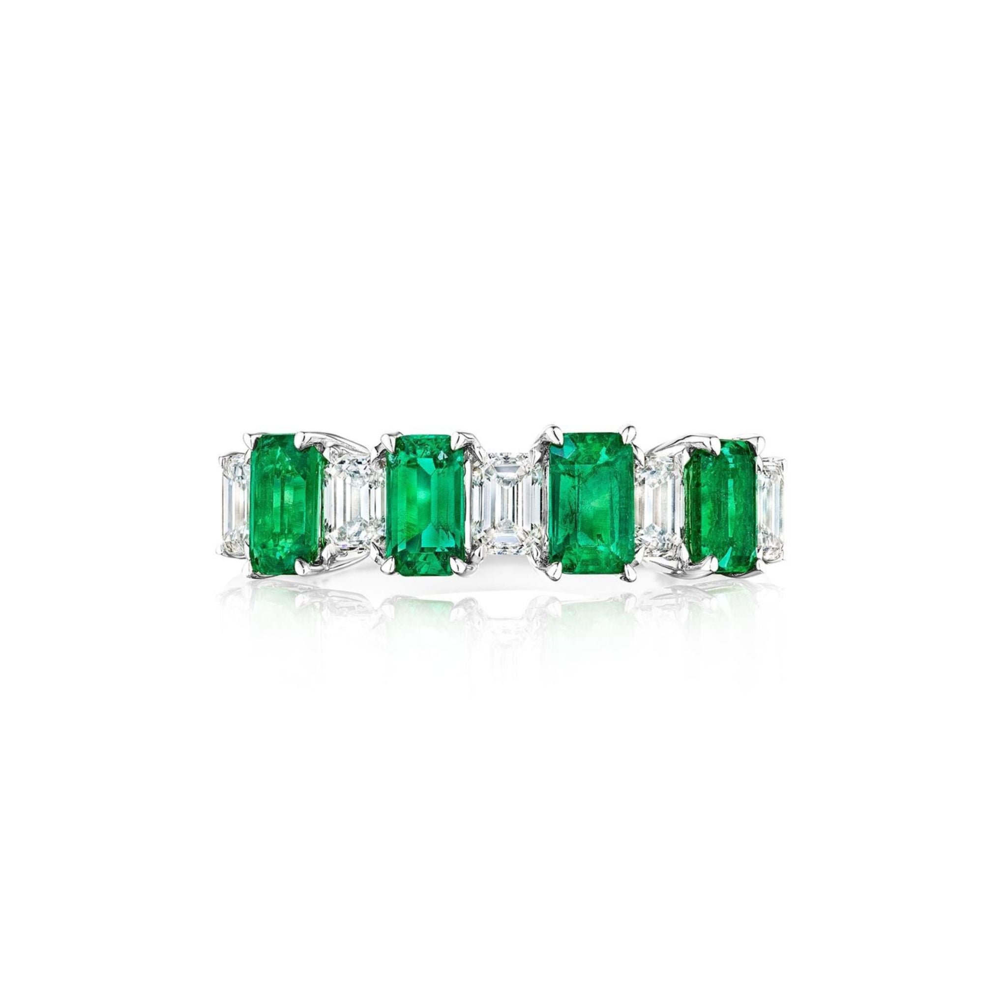 The Chroma Alternating Emerald and Diamond Half Eternity Band features 18K white gold with rectangular emerald gemstones and emerald cut diamonds in a modern design, shown on a white background.